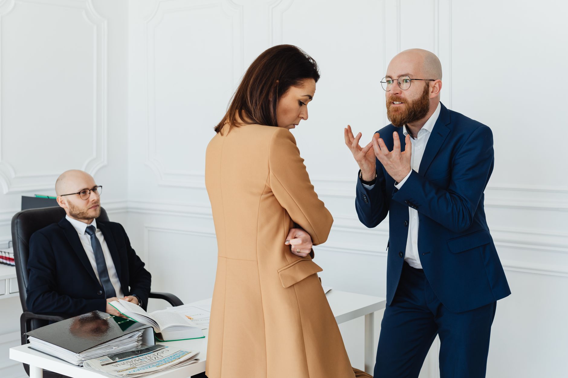 Business professionals in a tense meeting, representing a high-stakes corporate dispute