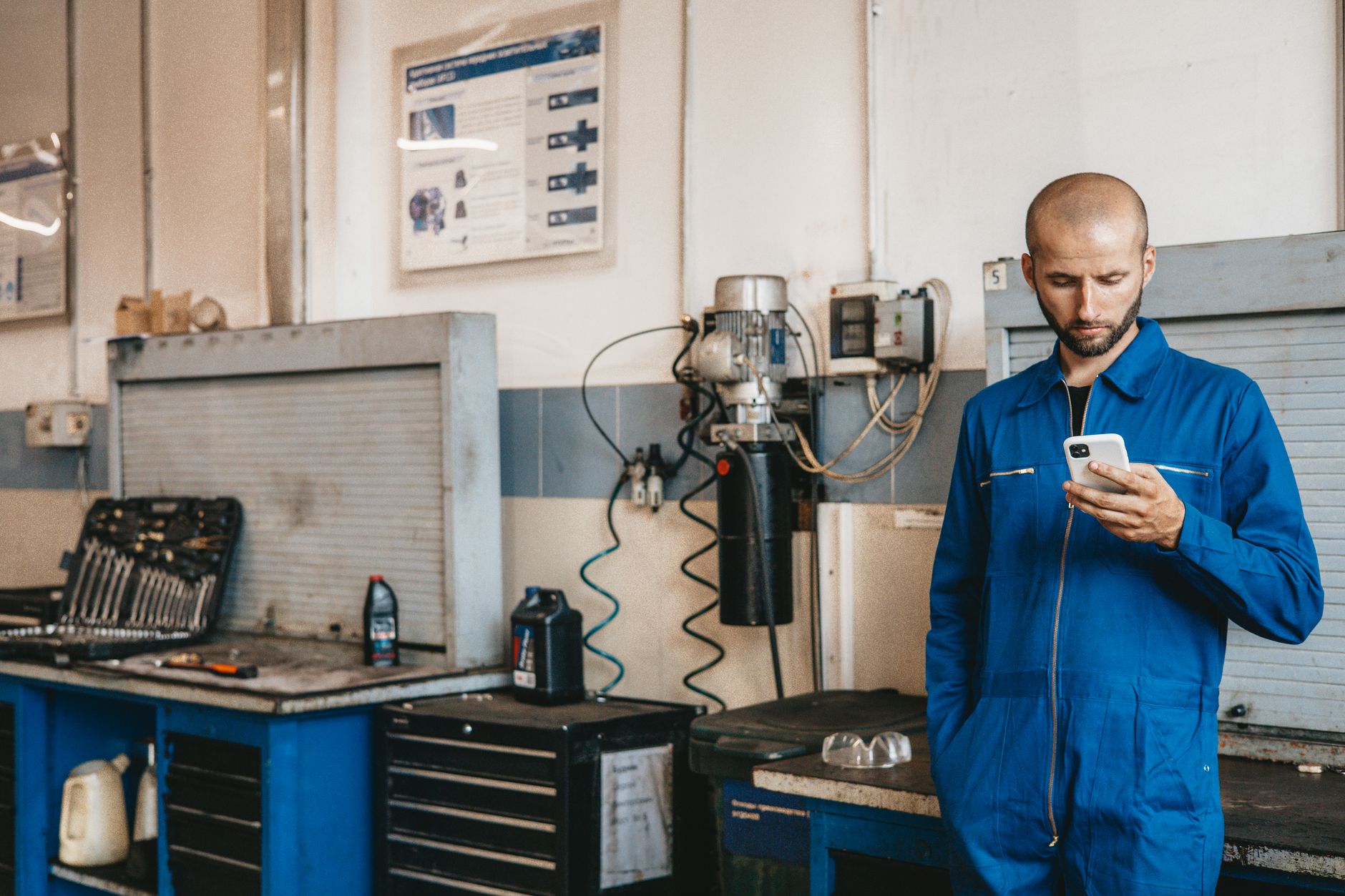 Technician inspecting a smartphone at a repair counter