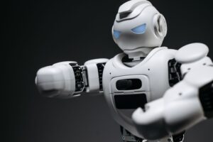 Humanoid Robots Are Everywhere on Video. Factories Are a Different Story. A humanoid robot standing in an industrial setting, representing the gap between robotic demos and real-world deployment