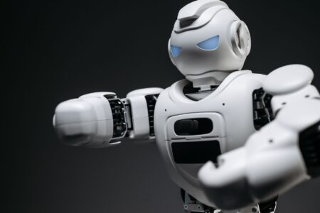 Humanoid Robots Are Everywhere on Video. Factories Are a Different Story. A humanoid robot standing in an industrial setting, representing the gap between robotic demos and real-world deployment