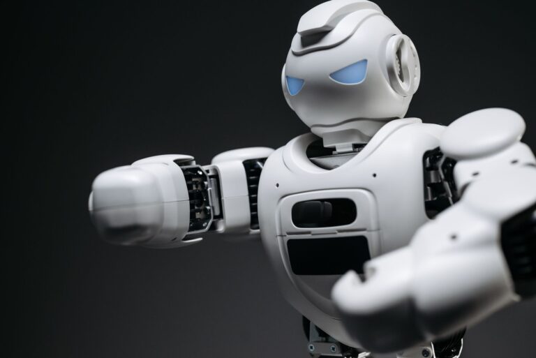 Humanoid Robots Are Everywhere on Video. Factories Are a Different Story. A humanoid robot standing in an industrial setting, representing the gap between robotic demos and real-world deployment