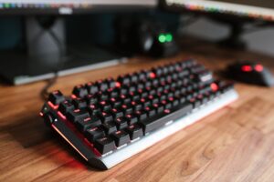 Long live the mechanical keyboard Mechanical keyboard on a wooden desk with backlighting