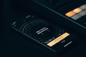 People Are Hating Apple Music’s Redesigned Black and White Logo Person holding a smartphone with a music streaming app open on screen