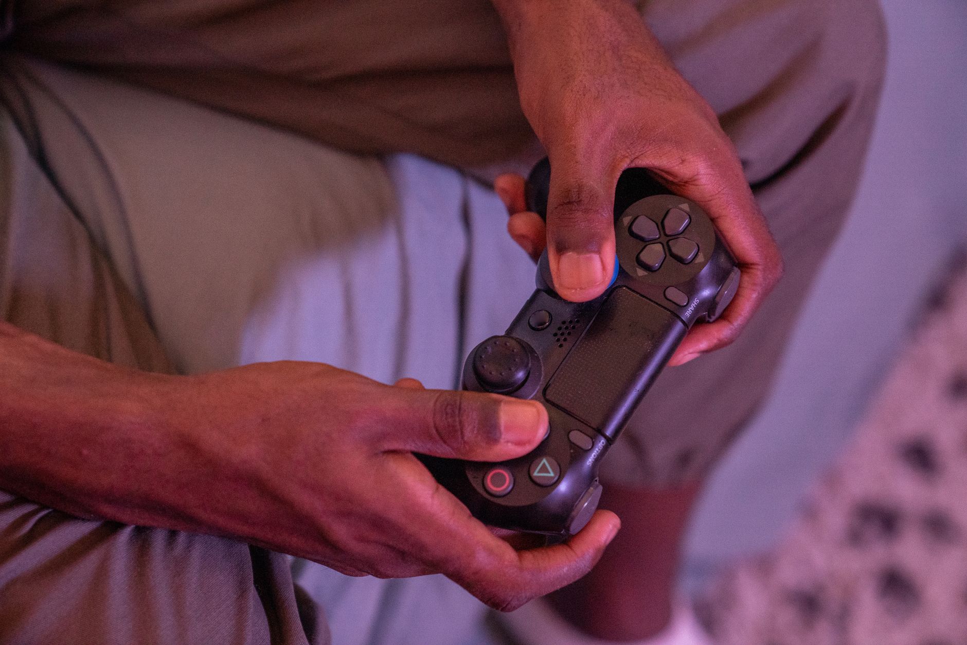 Person holding a compact video game controller in one hand