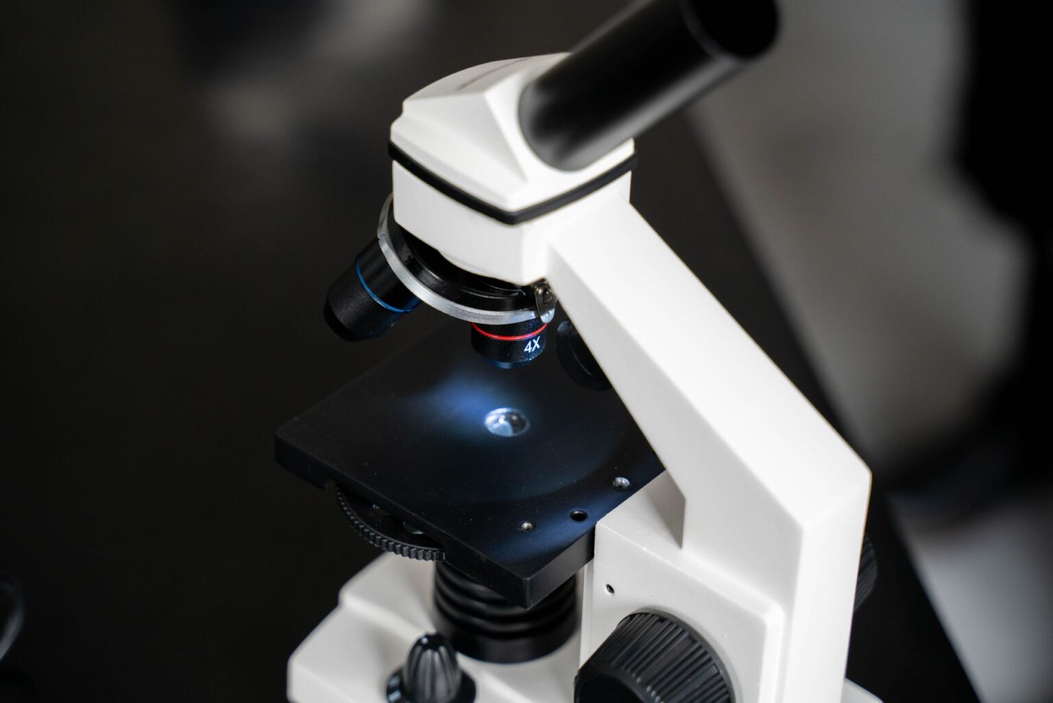 Researcher examining samples under a microscope in a university laboratory setting