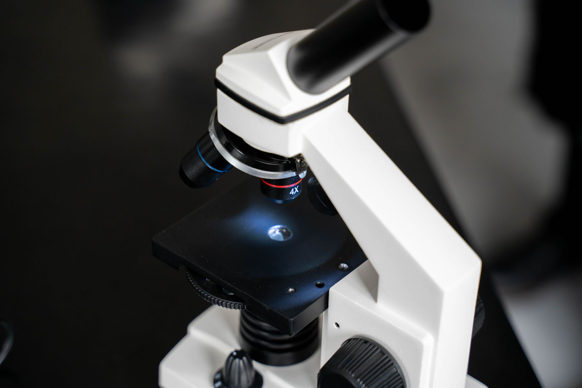 Researcher examining samples under a microscope in a university laboratory setting