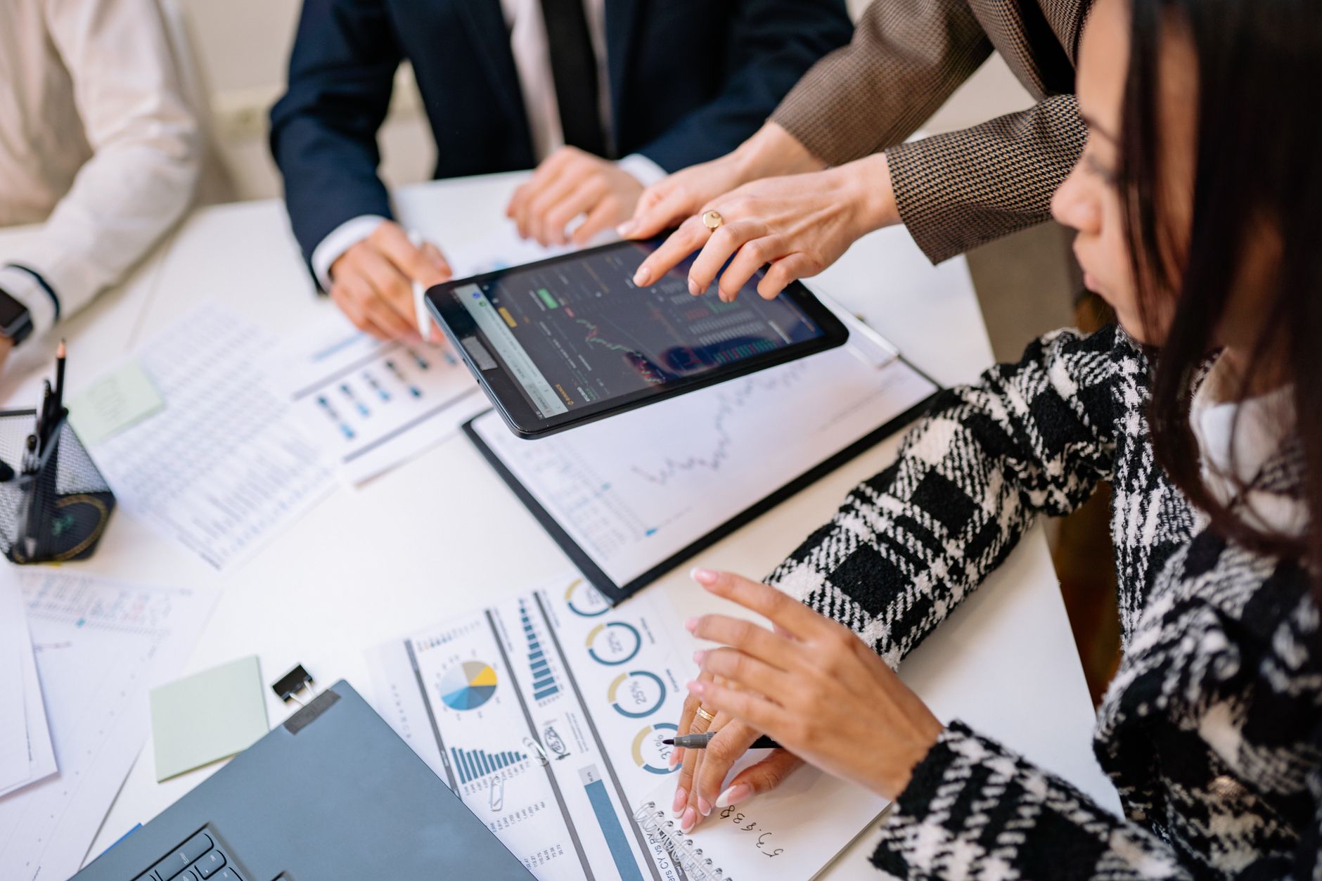 Employees working across enterprise technology systems in a large modern office