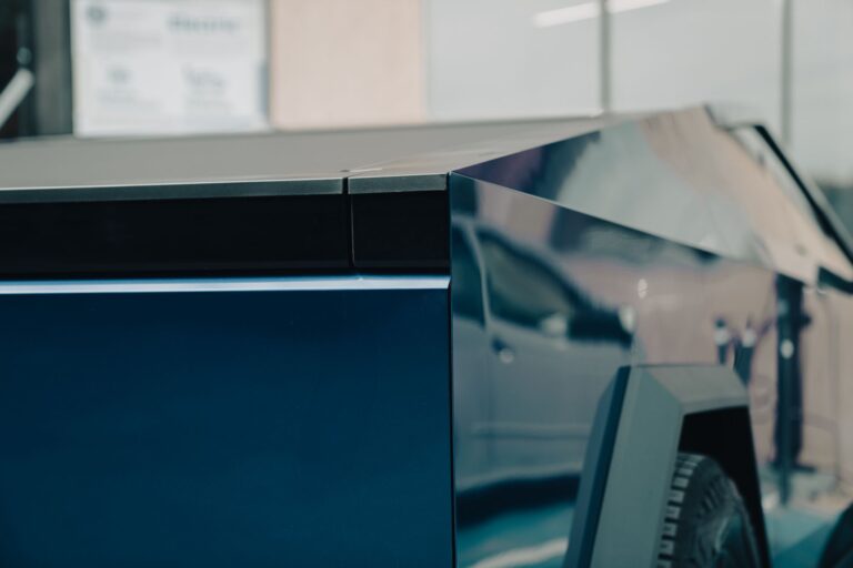 Tesla Eyes Cybercab Sales to Transport Companies Before 2026 Ends A sleek electric autonomous vehicle on a city road representing Tesla's Cybercab concept