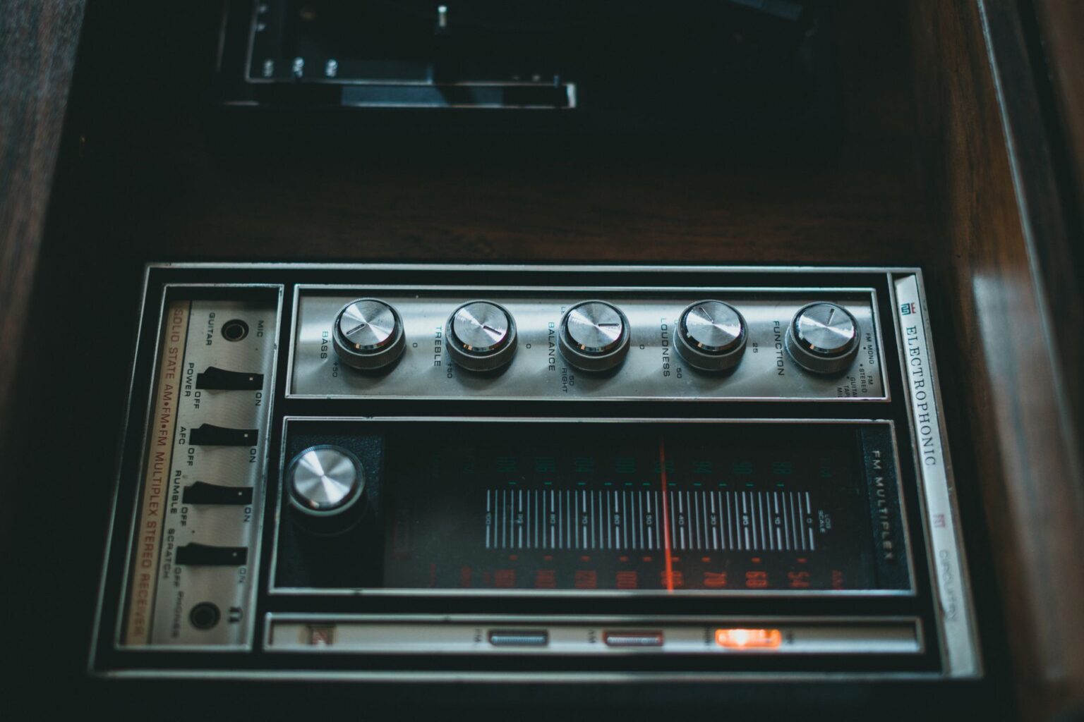 A stereo amplifier unit on a shelf next to audio equipment