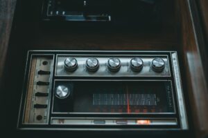 Do You Actually Need an Amplifier in Your Sound System? A stereo amplifier unit on a shelf next to audio equipment