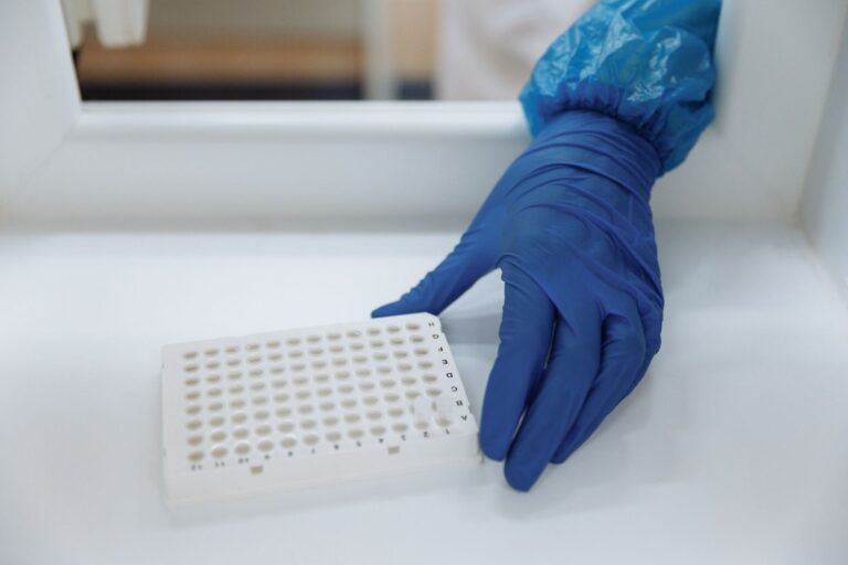 mRNA Vaccines, Gene Editing, and Military Dogs: Researcher working in a biotech laboratory with vials and equipment