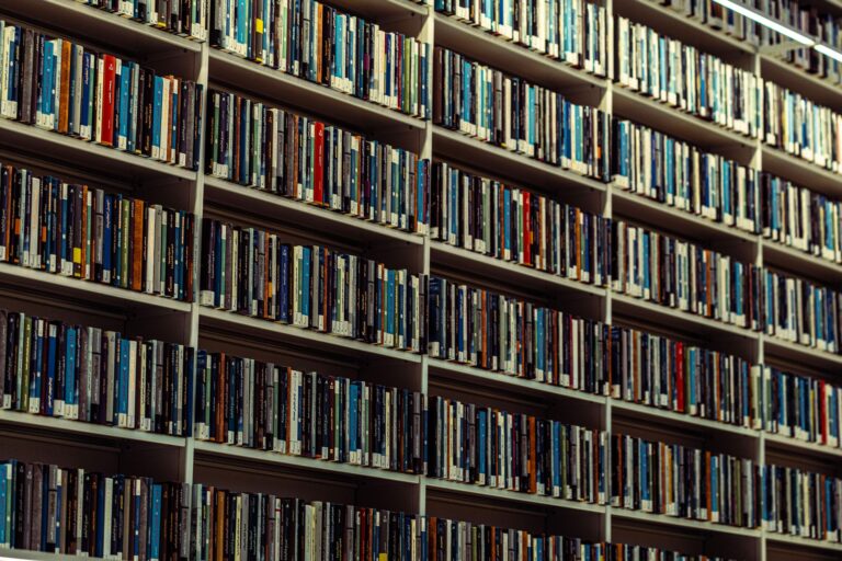 Open encyclopedia volumes on a library table representing reference documentation