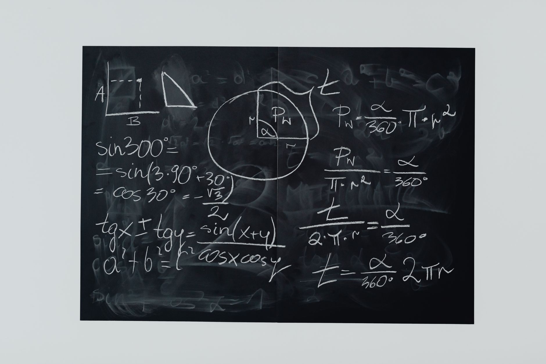 Complex mathematical equations written on a chalkboard representing theoretical proofs