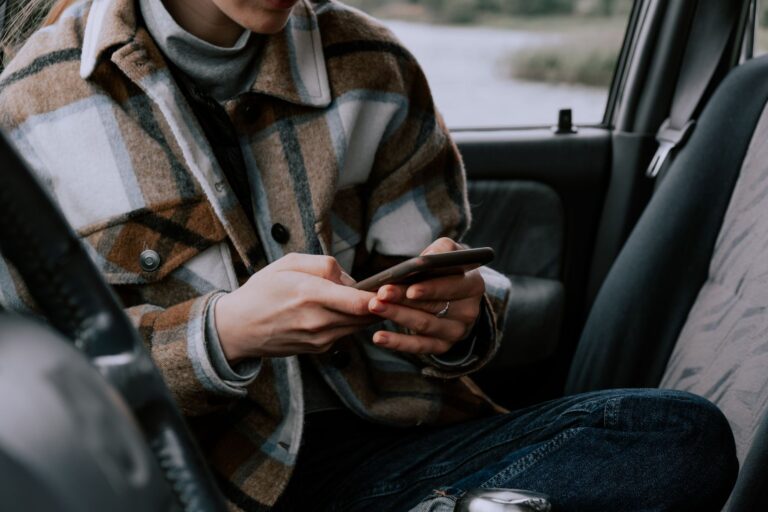 How to use Android’s Motion Assist feature to help with motion sickness Person using a smartphone while seated in a moving vehicle