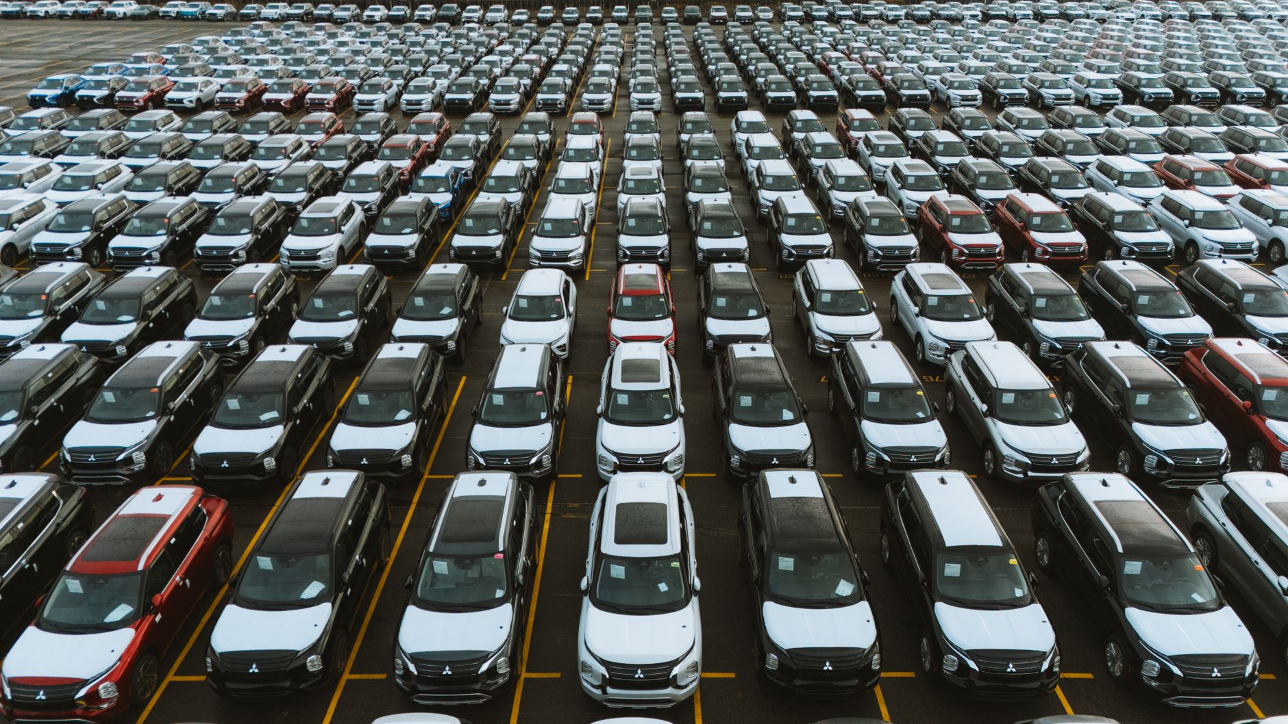 Row of commercial fleet transport vehicles in a parking facility