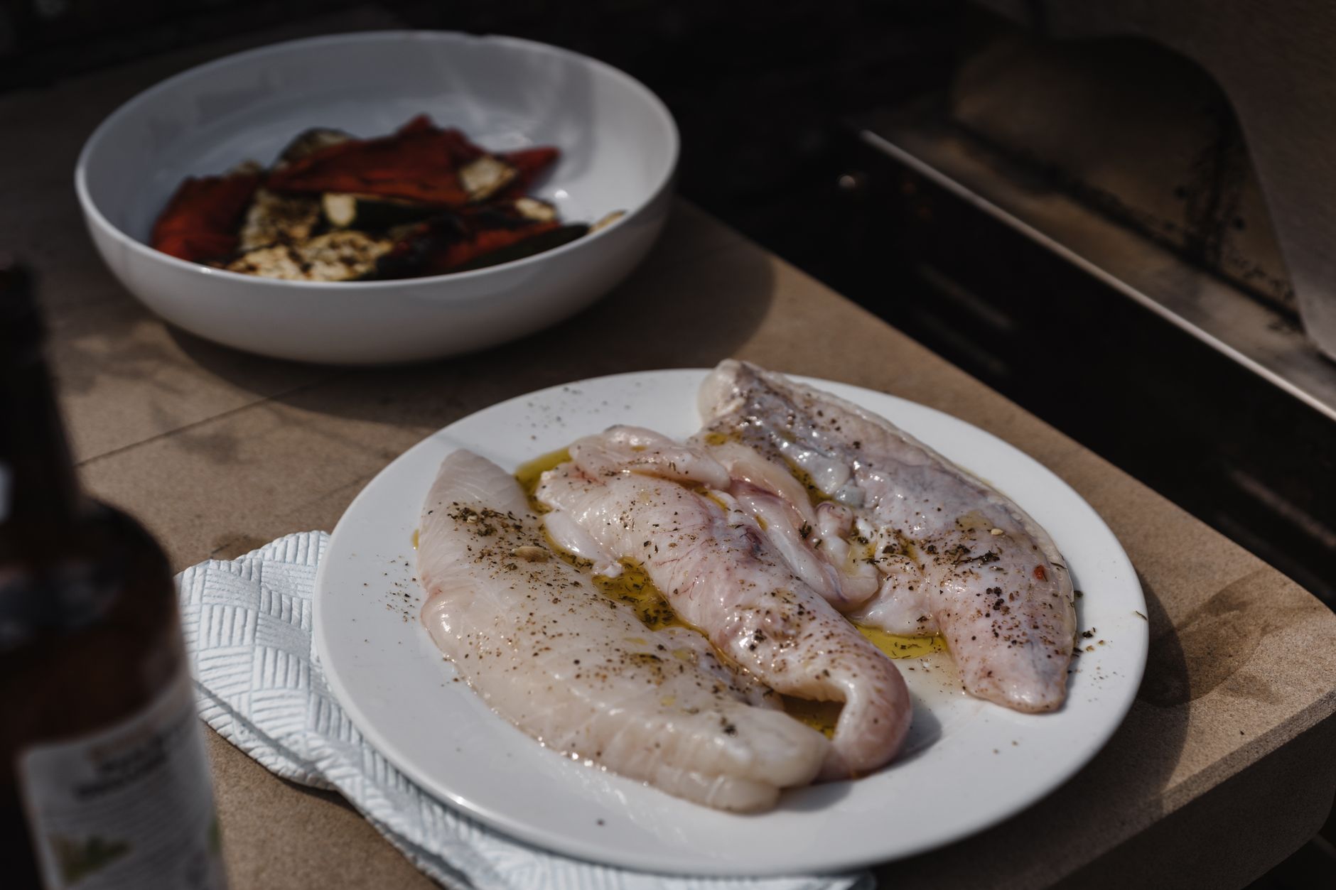 Thin salmon fillet cooking in a pan on a stovetop