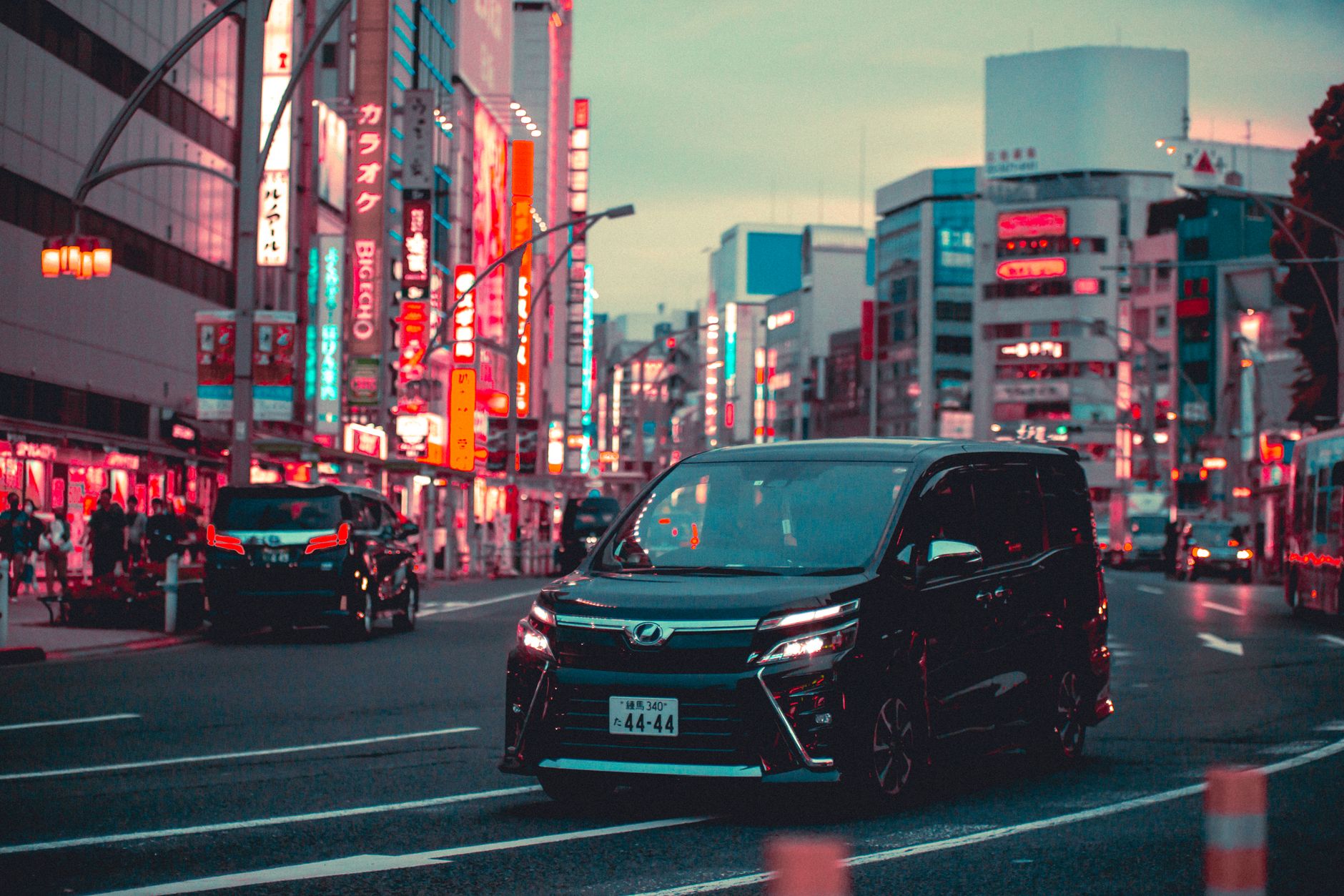 Busy Tokyo street with cars and pedestrians showing urban traffic conditions for robotaxi testing