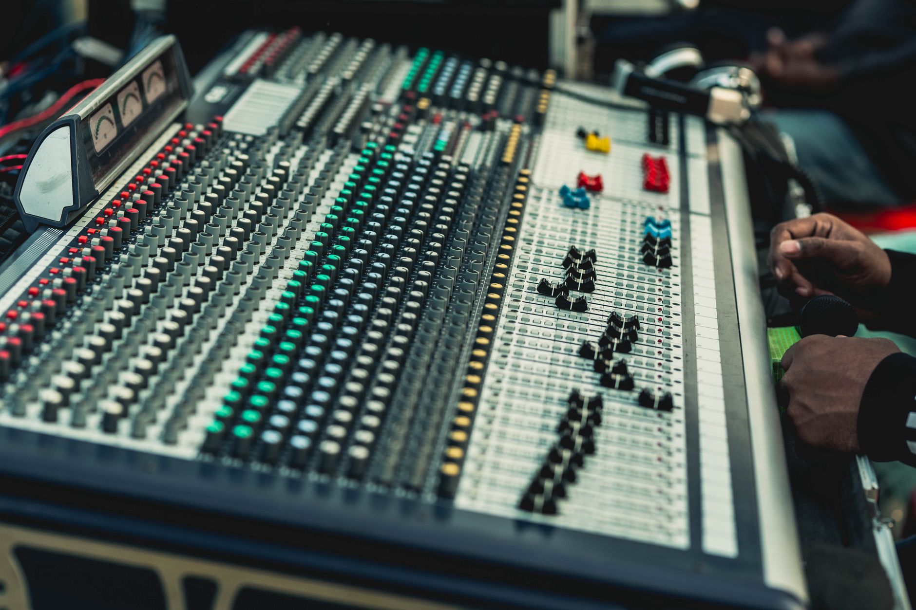 Sound engineer working at a mixing board in a professional recording studio