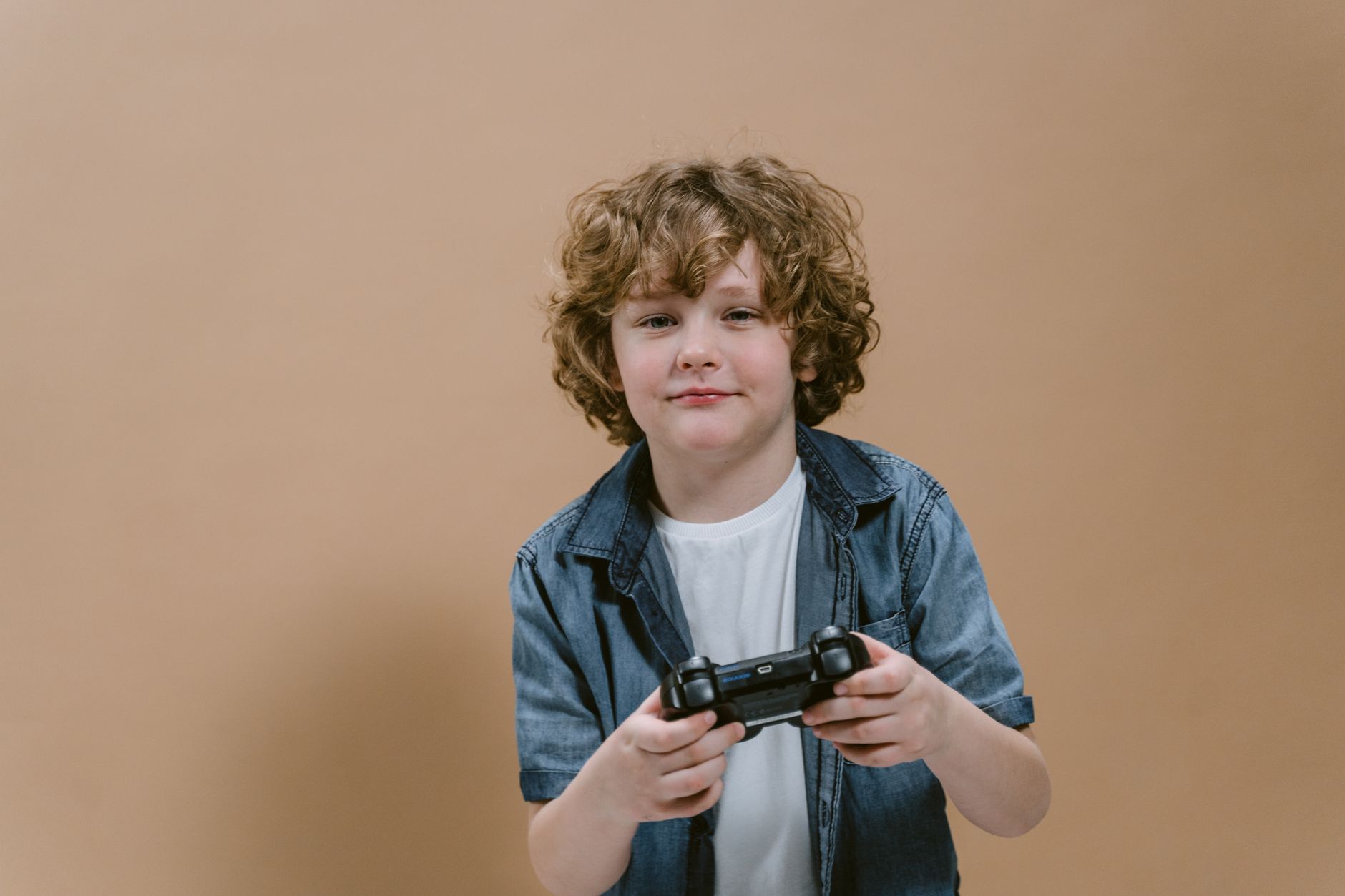Young child using a video game controller while seated