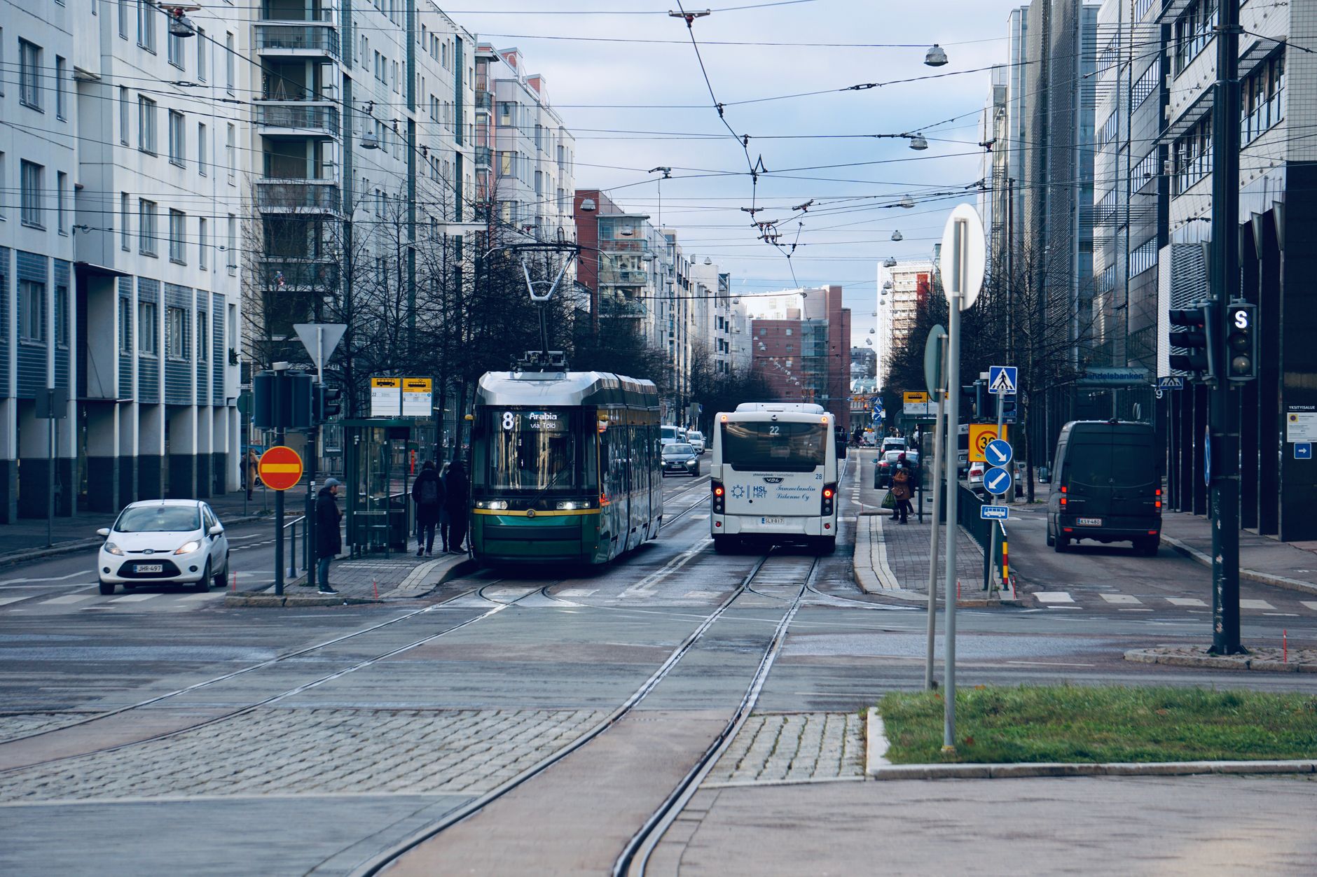 Electric bus driving through a modern city street
