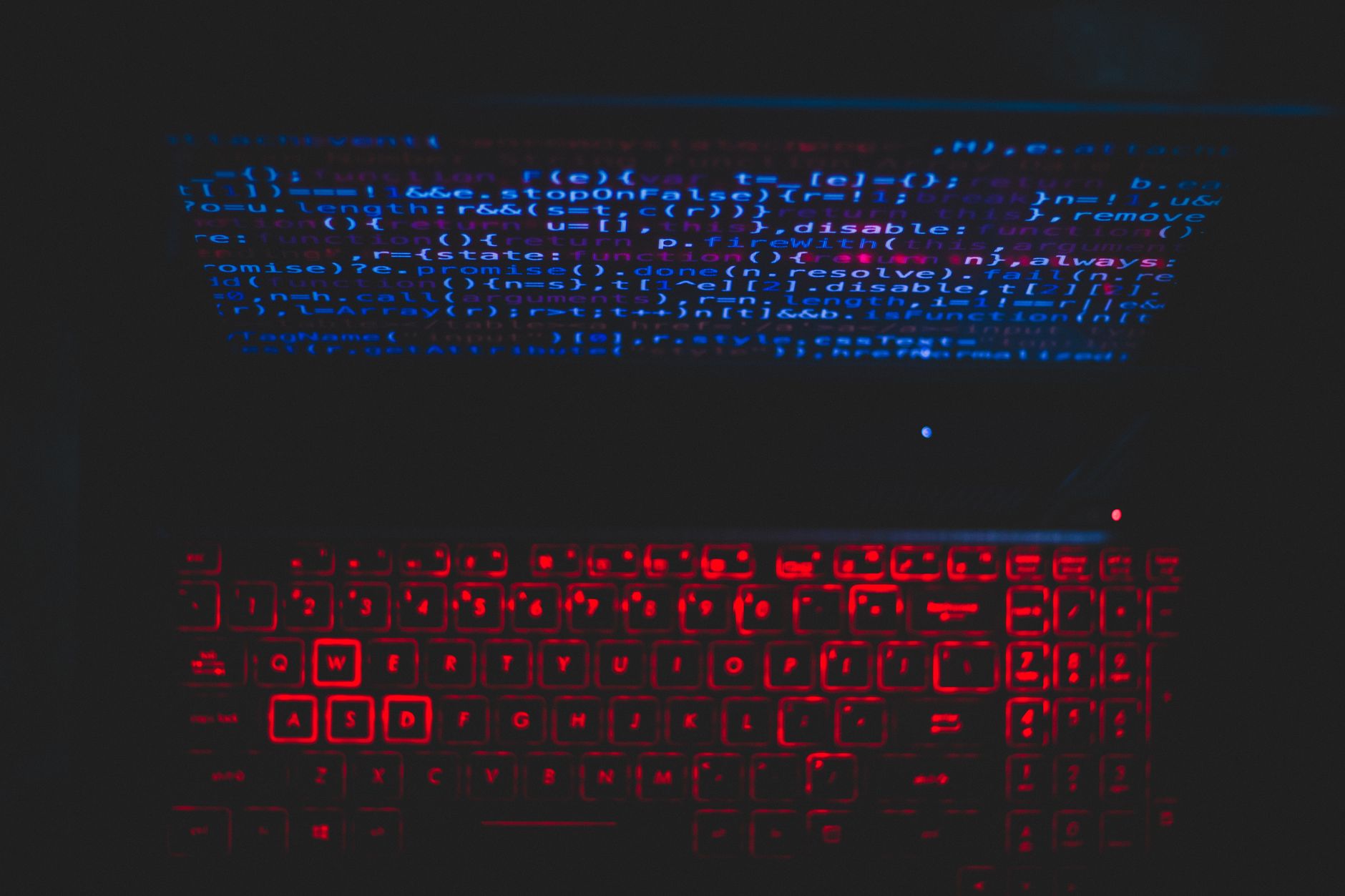 Developer working on cybersecurity filtering code on a monitor