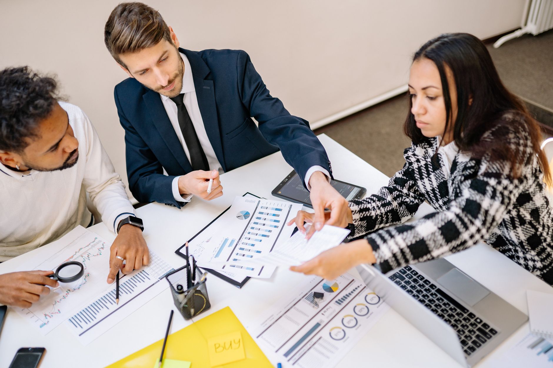 Executives reviewing operational data on screens during a strategy session