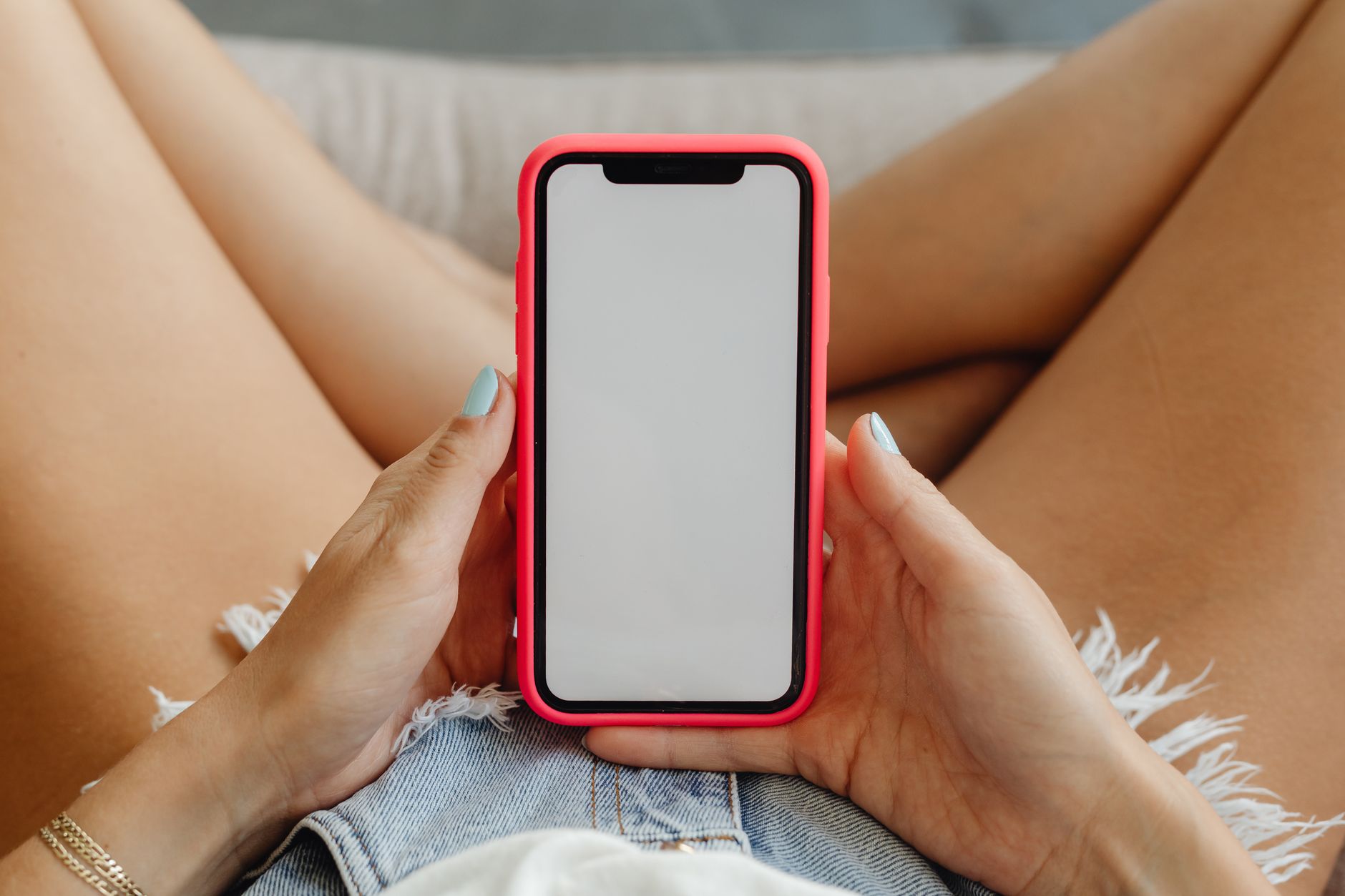 Person holding a modern smartphone while deciding between mobile options