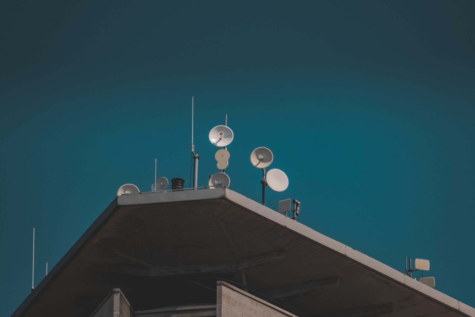 Satellite communication dish against a dark night sky