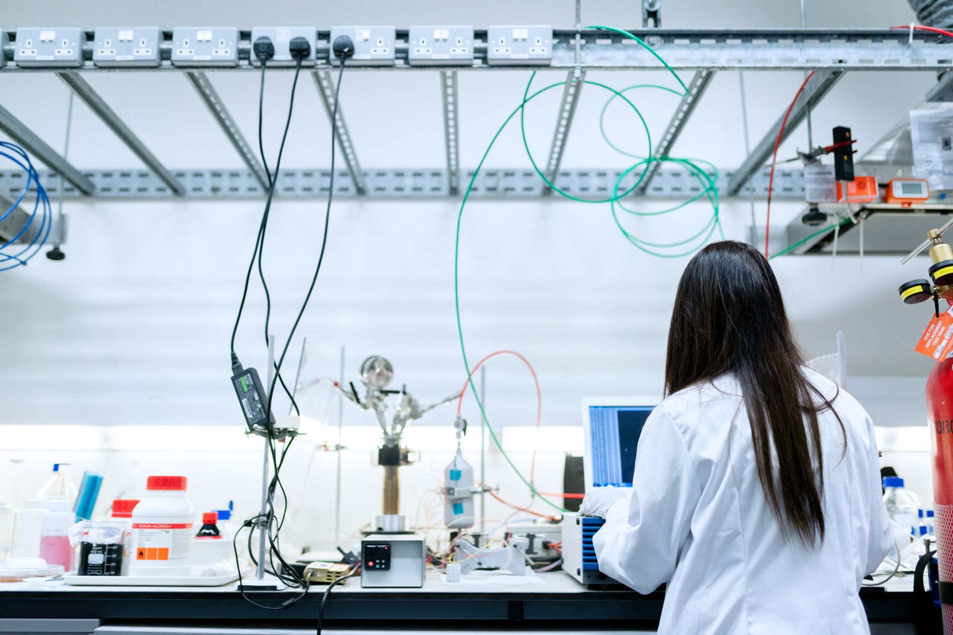 Researcher working in a physics laboratory reviewing scientific data