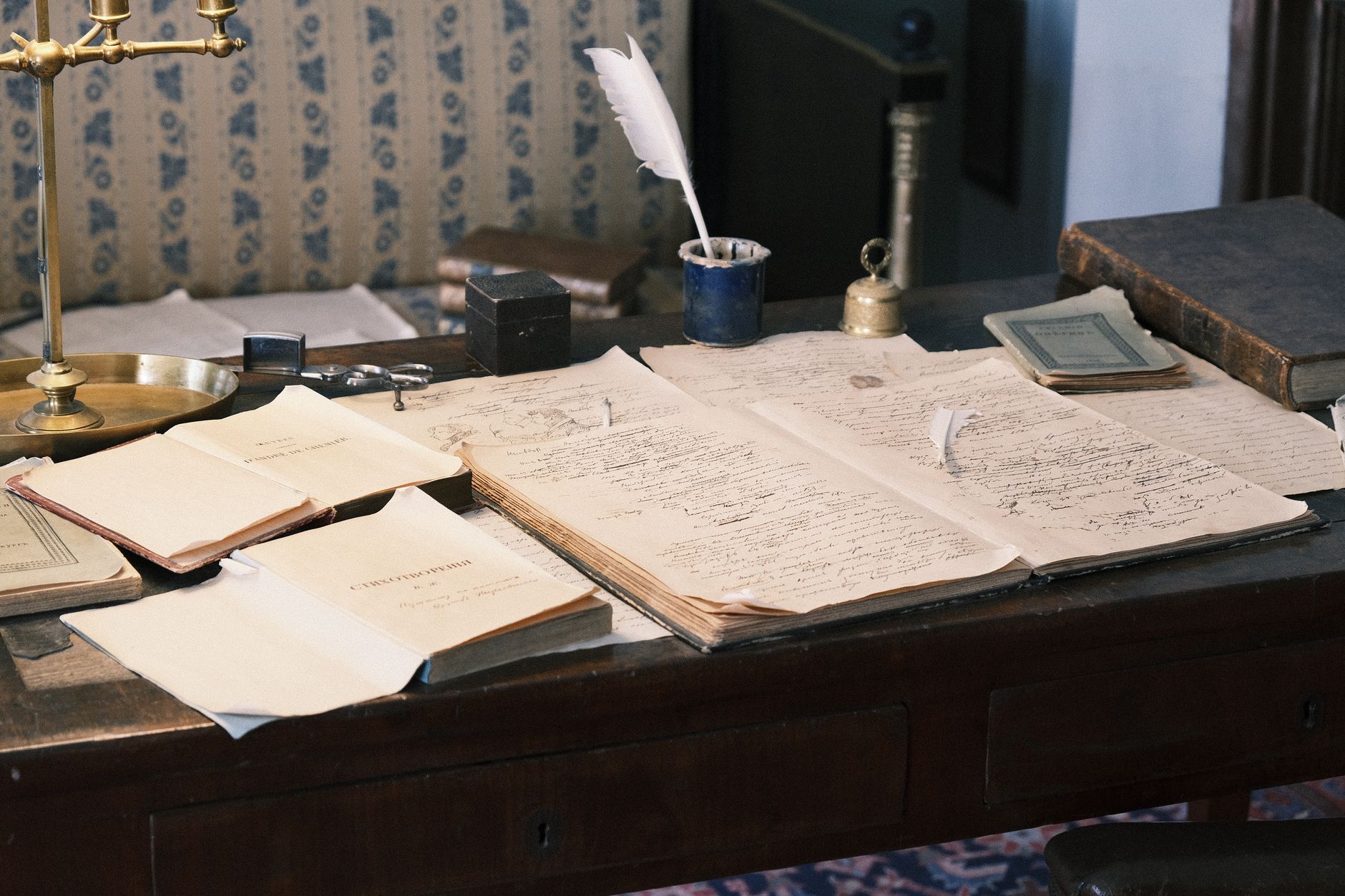 Stack of official government documents on a desk with reading glasses nearby