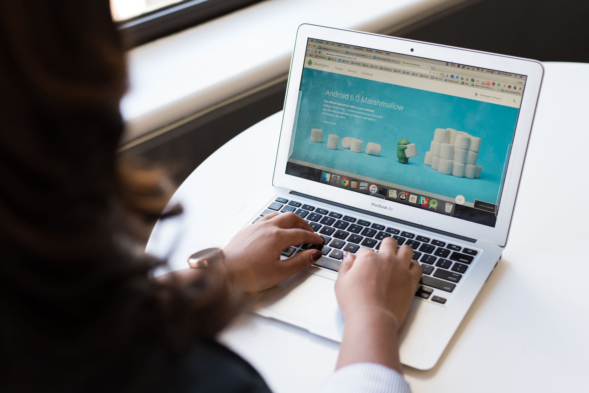 Person browsing a domain registration website on a laptop screen